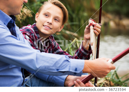 Fisher boy showing catch fish 36723594