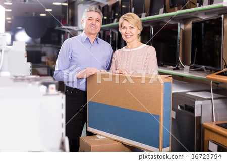 happy mature married couple in shop packed household appliances into boxes happy mature married couple in shop packed household appliances into boxes 36723794