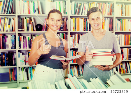 Teenagers buying new books and showing thumbs up Teenagers buying new books and showing thumbs up 36723839