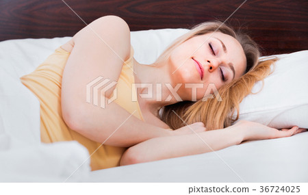Woman in pyjamas having a nap in the bed 36724025