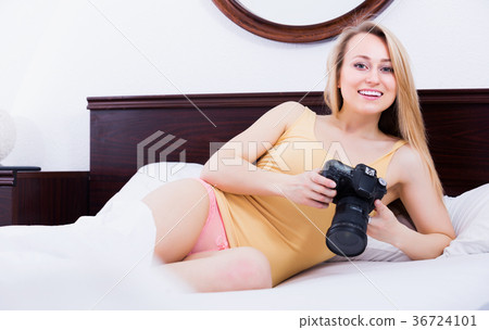 Woman playing with a camera 36724101