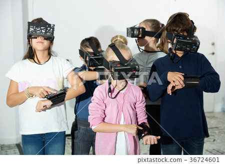 Enthusiastic children in virtual reality glasses in quest room 36724601