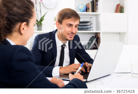 Business male assistant wearing formalwear using laptop 36725428
