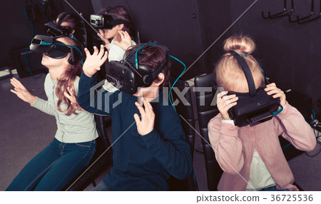 Enthusiastic children in virtual reality glasses in quest room 36725536