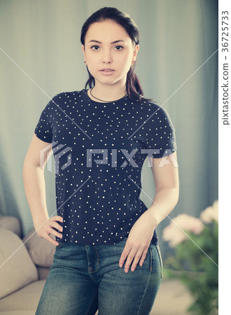 Girl standing with hand on waist Girl standing with hand on waist 36725733