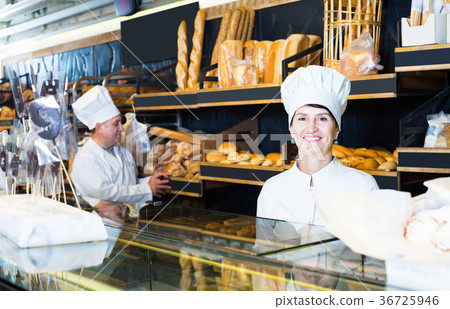 professional female baker with fresh bread in bakery 36725946