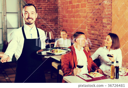 Waiter showing country restaurant to visitors 36726481