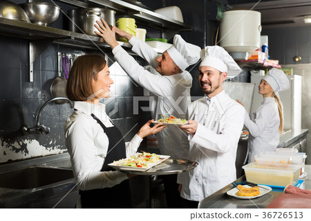 Beautiful female waiter taking ordered dishes 36726513