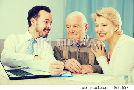 Woman and old man consider contract Woman and old man consider contract 36726571