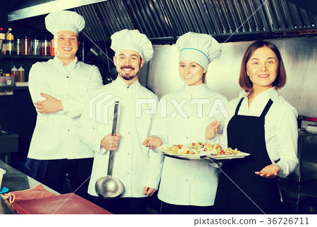 working woman waiter collecting dishes from restaurant’s kitchen 36726711