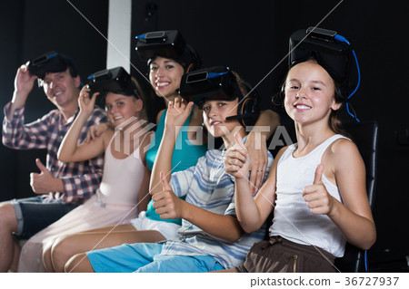 Smiling aughter watching the video with family Smiling aughter watching the video with family 36727937