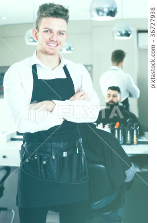 Young guy displaying his workplace at hairdressing salon 36727938