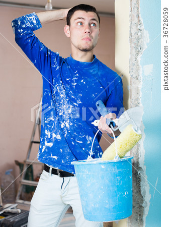 Perplexed worker inspecting room 36728059