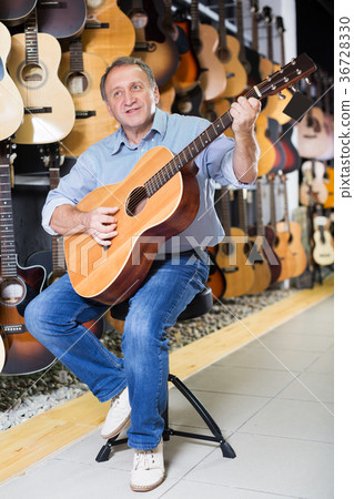Man is playing on acoustic guitar Man is playing on acoustic guitar 36728330