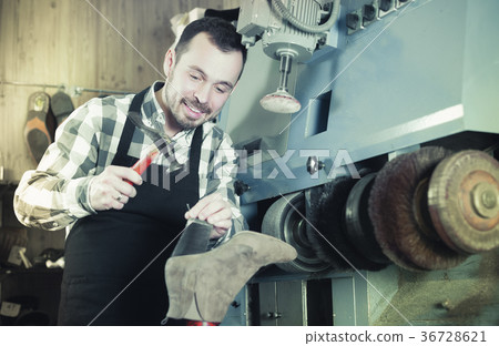 Male worker repairing shoe Male worker repairing shoe 36728621