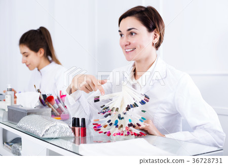 Manicurist demonstrating nail polish 36728731