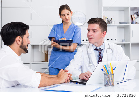 Doctor listening to patient complaints at clinic Doctor listening to patient complaints at clinic 36728826