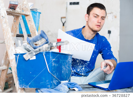 Builder foreman with laptop and blueprint paper Builder foreman with laptop and blueprint paper 36728827