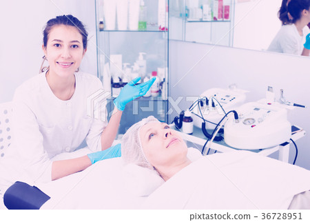 Woman making beauty procedures for face Woman making beauty procedures for face 36728951