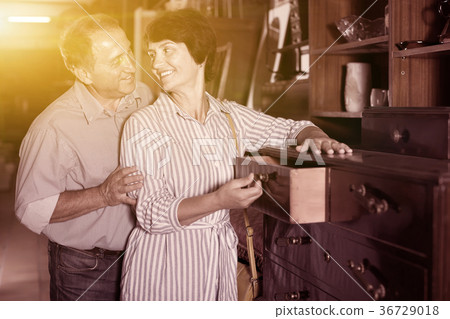 woman with her husband are buying antique curbstone in store 36729018