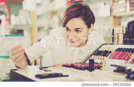 Female customer searching for reliable make-up products Female customer searching for reliable make-up products 36729266