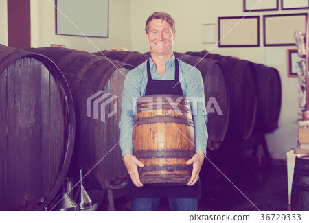 Man carrying wine wood in hands 36729353