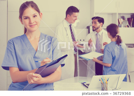 Female doctor writing notes on clipboard Female doctor writing notes on clipboard 36729368