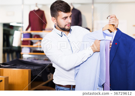 male client choosing classic jacket 36729612
