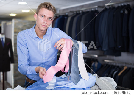 Portrait of man customer choosing tie 36729632