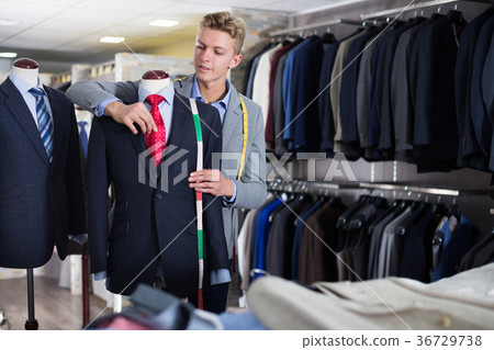 Adult male in shirt measuring jacket Adult male in shirt measuring jacket 36729738