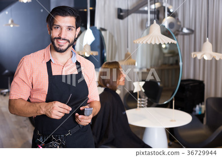 smiling man hairdresser and woman in salon 36729944