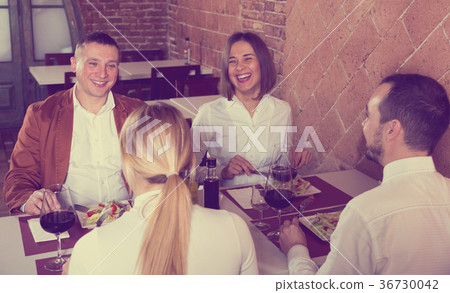 Friends enjoying delicious meal in country restaurant 36730042