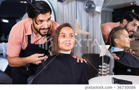 Male professional with female talking about hairstyle 36730086