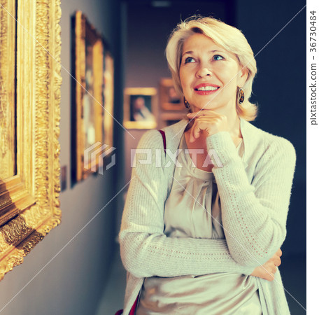 Portrait of adult woman near picture collection Portrait of adult woman near picture collection 36730484