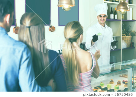 Cheerful chef man is serving visitors 36730486