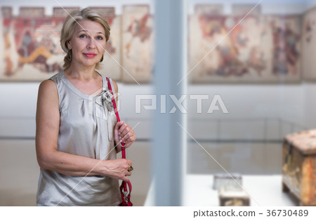 Mature woman near the ancient exhibit Mature woman near the ancient exhibit 36730489
