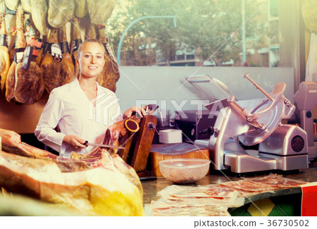 woman cutting dried ham woman cutting dried ham 36730502