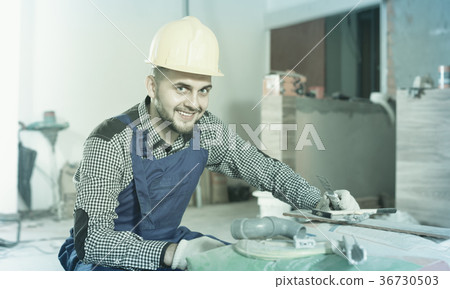 Male worker is preparing for repair in the room 36730503