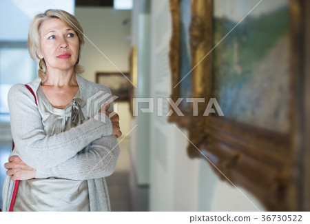 Woman looking at picture collection Woman looking at picture collection 36730522