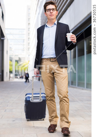 Smiling man worker going with baggage Smiling man worker going with baggage 36730535