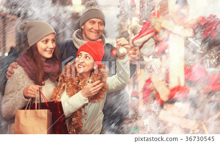 Portrait of family couple with teen girl at Christmas fair 36730545
