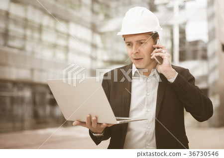 Cheerful male talking about work at the laptop Cheerful male talking about work at the laptop 36730546