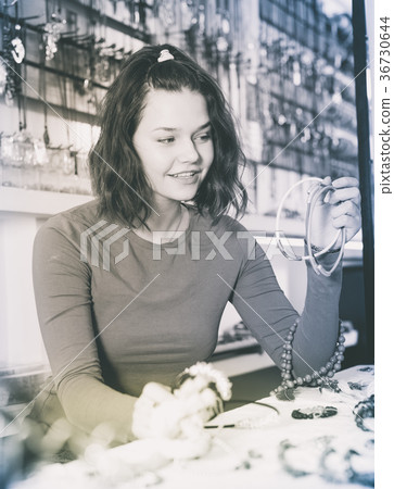 Woman showing different pendant Woman showing different pendant 36730644