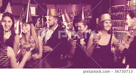 Portrait of young women and men in caps with cocktails Portrait of young women and men in caps with cocktails 36730713