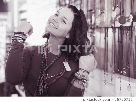 Girl seller offering fashionable bracelets and pendants Girl seller offering fashionable bracelets and pendants 36730735