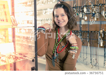 Girl seller offering fashionable bracelets and pendants 36730751