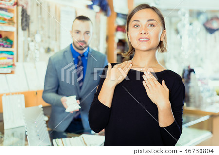 Woman customer trying chainlet with pendant Woman customer trying chainlet with pendant 36730804