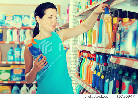 Smiling female want to buying cleaners in bottle 36730947
