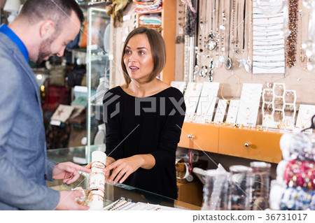 Positive seller showing bracelets for consumer 36731017