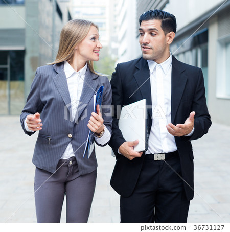 Businesswoman and her partner are going to office and talking about project 36731127
